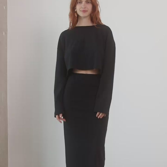 Oversized Organic Cotton Long Sleeve Crop Top in Black worn with a matching black skirt, showcasing a relaxed, stylish look.