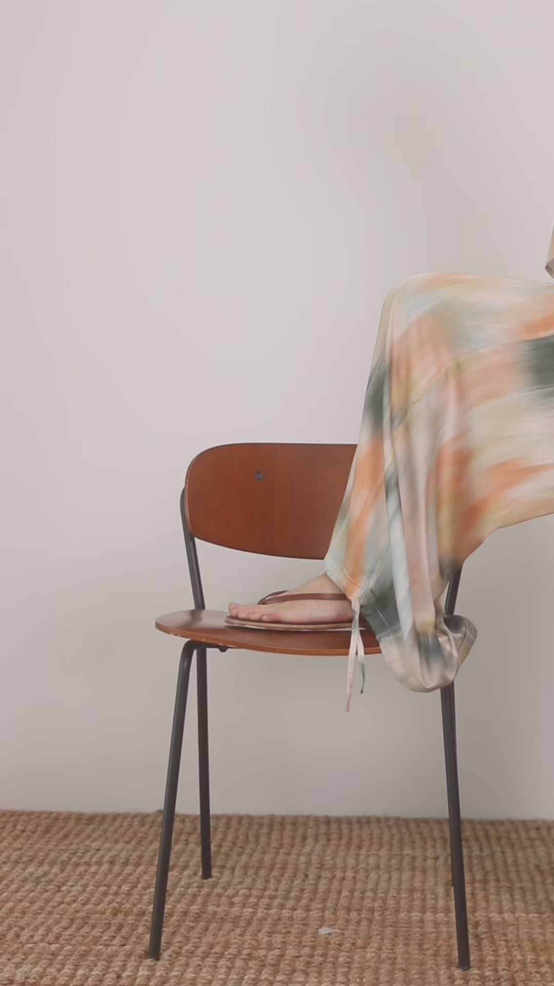 Printed Ecovero Viscose Wide-Leg Trousers draping effortlessly over a wooden chair.