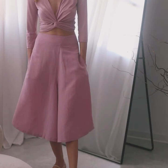 Model wearing rose skirt culottes styled with a matching wrap top, showcasing elegance and comfort.