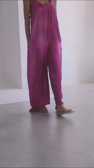Model wearing a lightweight purple printed jumpsuit with adjustable shoulder straps, ideal for summer style.