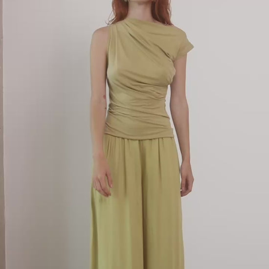 Wide Ecovero Trousers in Soft Olive modeled by a model, showcasing a relaxed oversized silhouette.