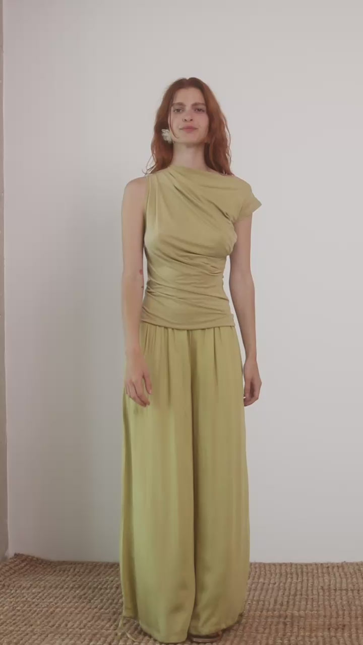 Wide Ecovero Trousers in Soft Olive modeled by a model, showcasing a relaxed oversized silhouette.