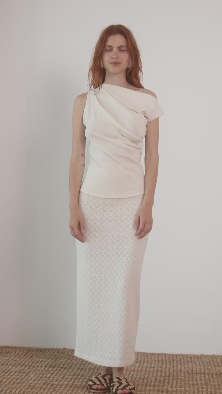 Model wearing Banana Pineapple Drape Neckline Top in Ecru with draped neckline and elegant styling.